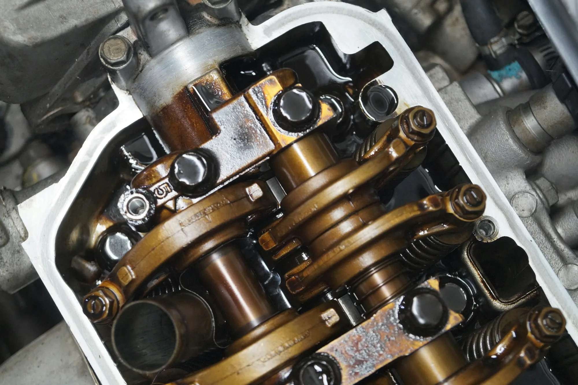 Close-up of an engine valvetrain with camshaft and rocker arms exposed
