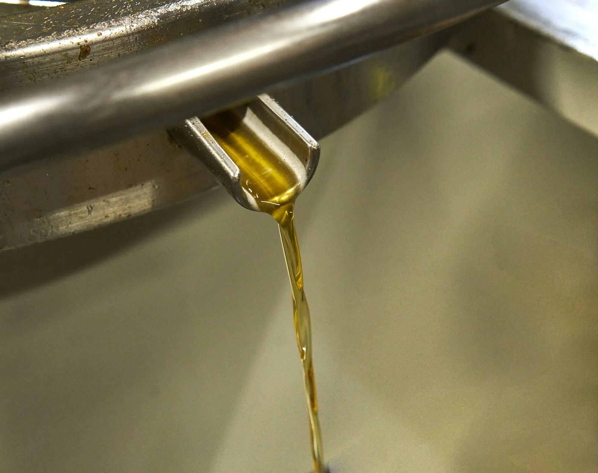 Fresh motor oil being poured into an engine