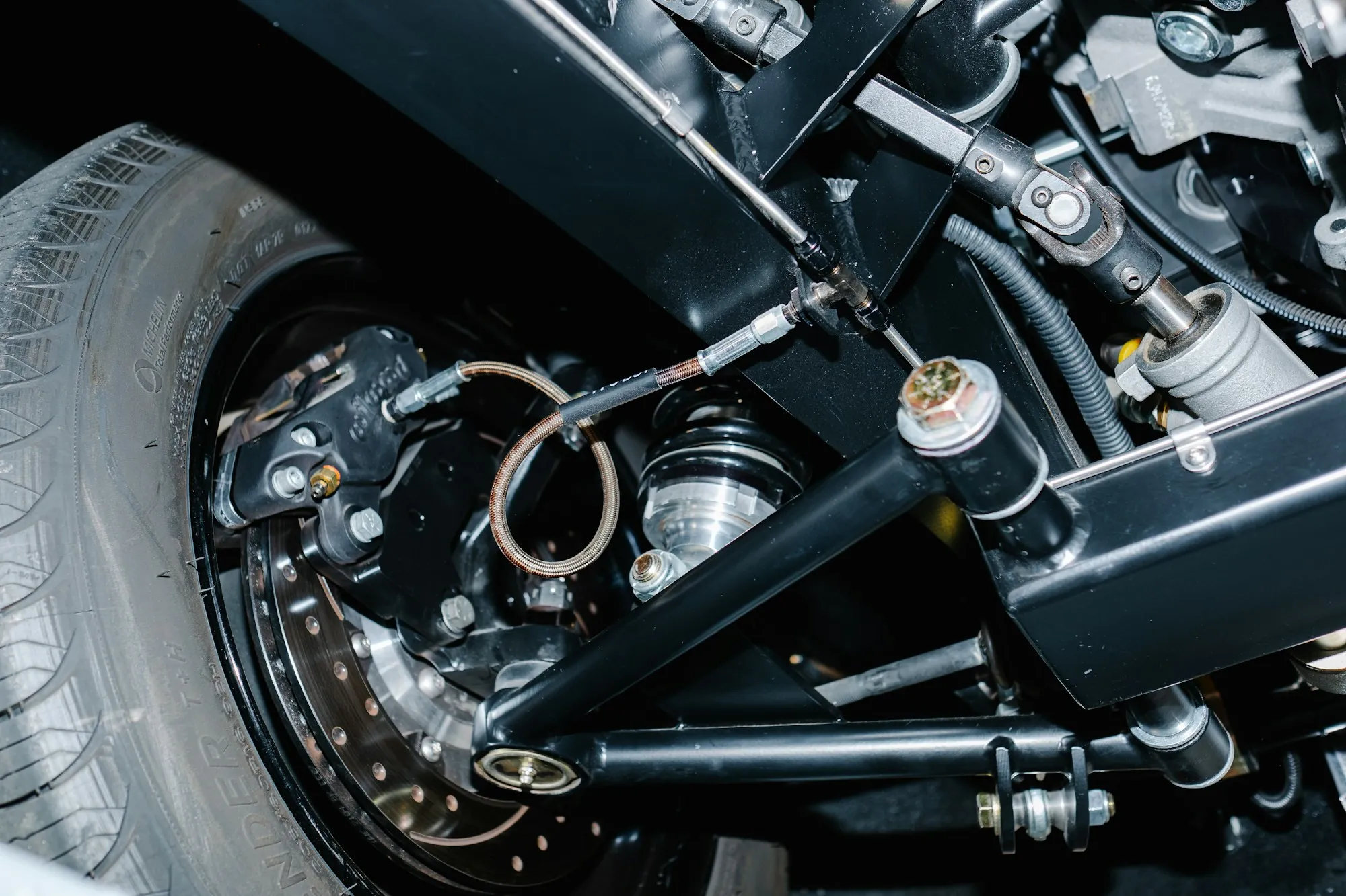 Close-up of a vehicle suspension assembly with spring and strut
